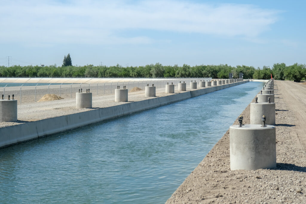 Concrete footings installed along an irrigation canal.