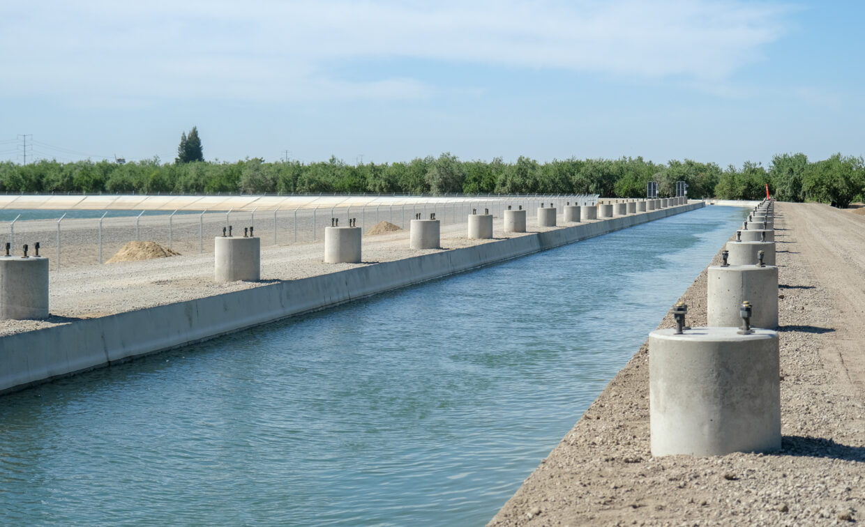 Concrete footings installed along an irrigation canal.