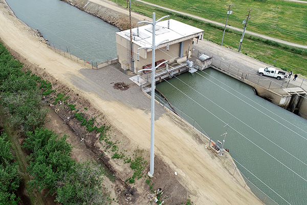 Aerial shot of small hydroelectric station over a canal