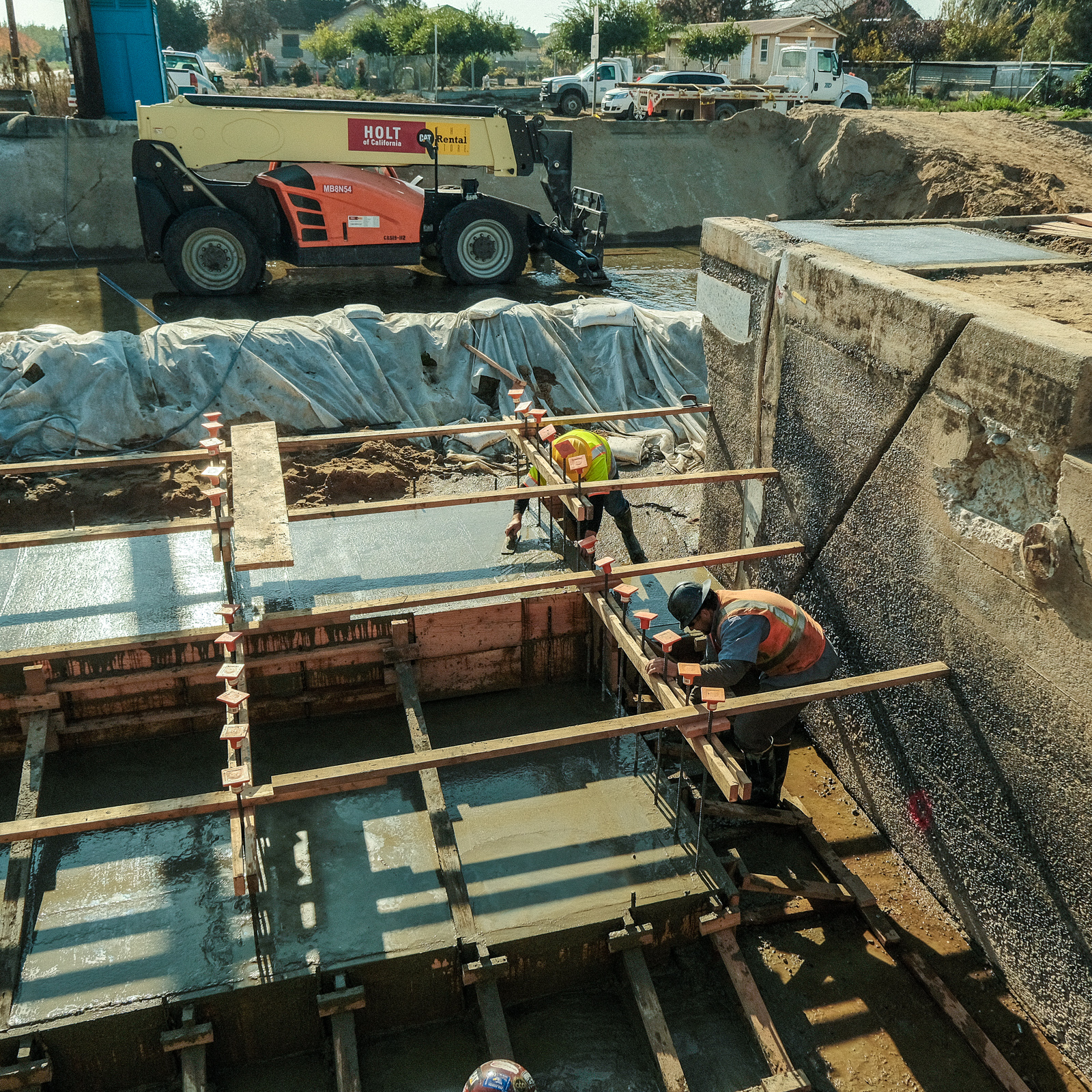 Construction crew rebuilds an irrigation canal drop.